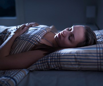 Woman with sleep apnea in The Woodlands, TX sleeping in bed