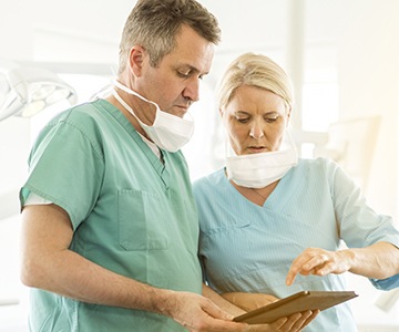 Two doctors looking at patient chart