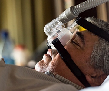 Man with CPAP nose mask