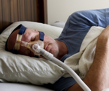 Man sleeping soundly with CPAP mask