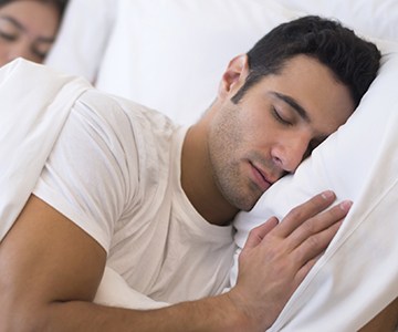 Man sleeping soundly in bed