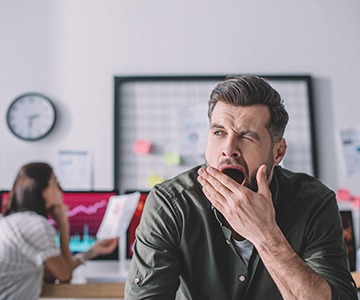a person yawning while at work 