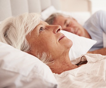 Woman awake next to snoring man