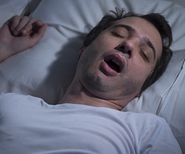 Snoring man in bed