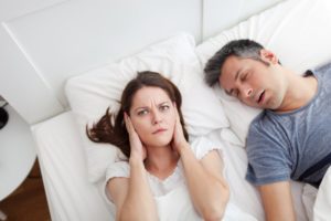 man snoring wife upset covering ears