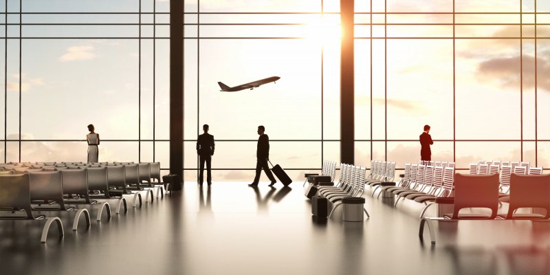 Picture of airport, passenger with suitcase walking by