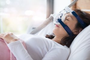 Woman sleeping with a CPAP